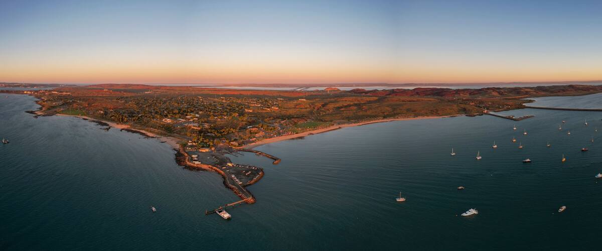 Aerial view of tranquil sunset over the beautiful Dampier foreshore with boats in the harbor, Karratha, Western Australia.