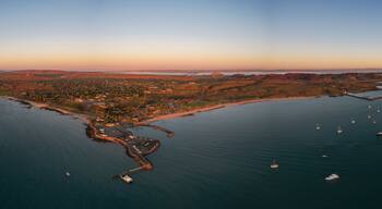 Aerial view of tranquil sunset over the beautiful Dampier foreshore with boats in the harbor, Karratha, Western Australia.