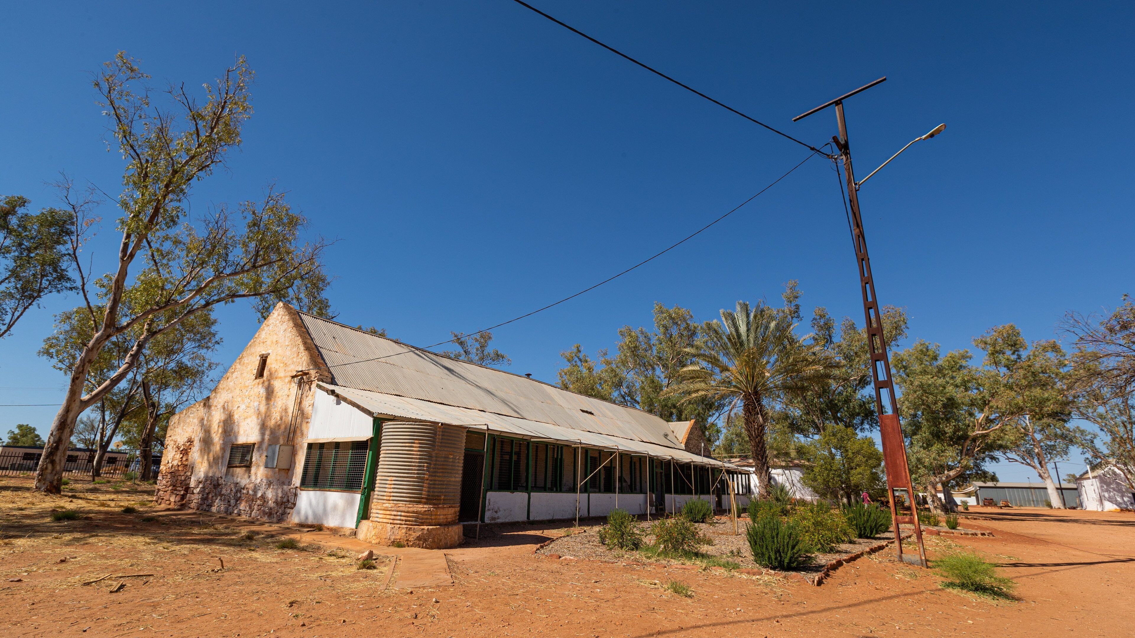 Hermannsburg featuring farmland, a small town or village and desert views