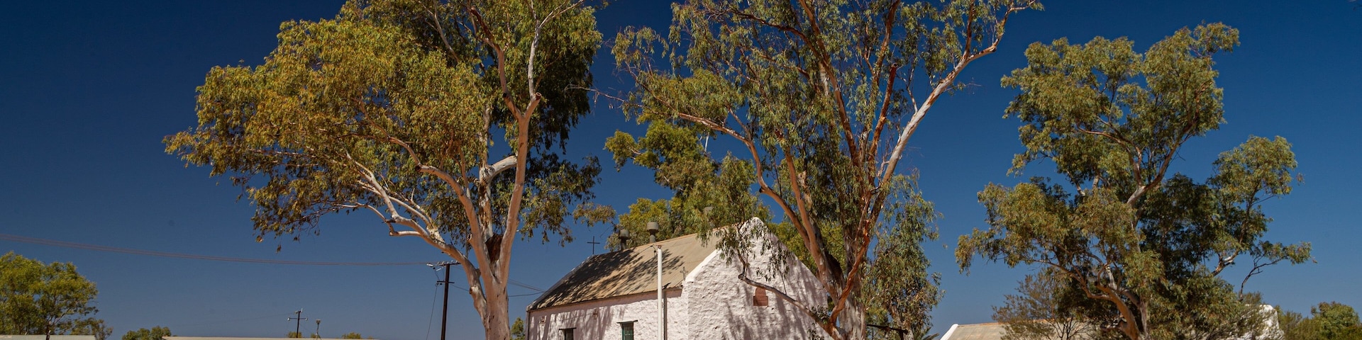 Hermannsburg showing farmland, desert views and a small town or village