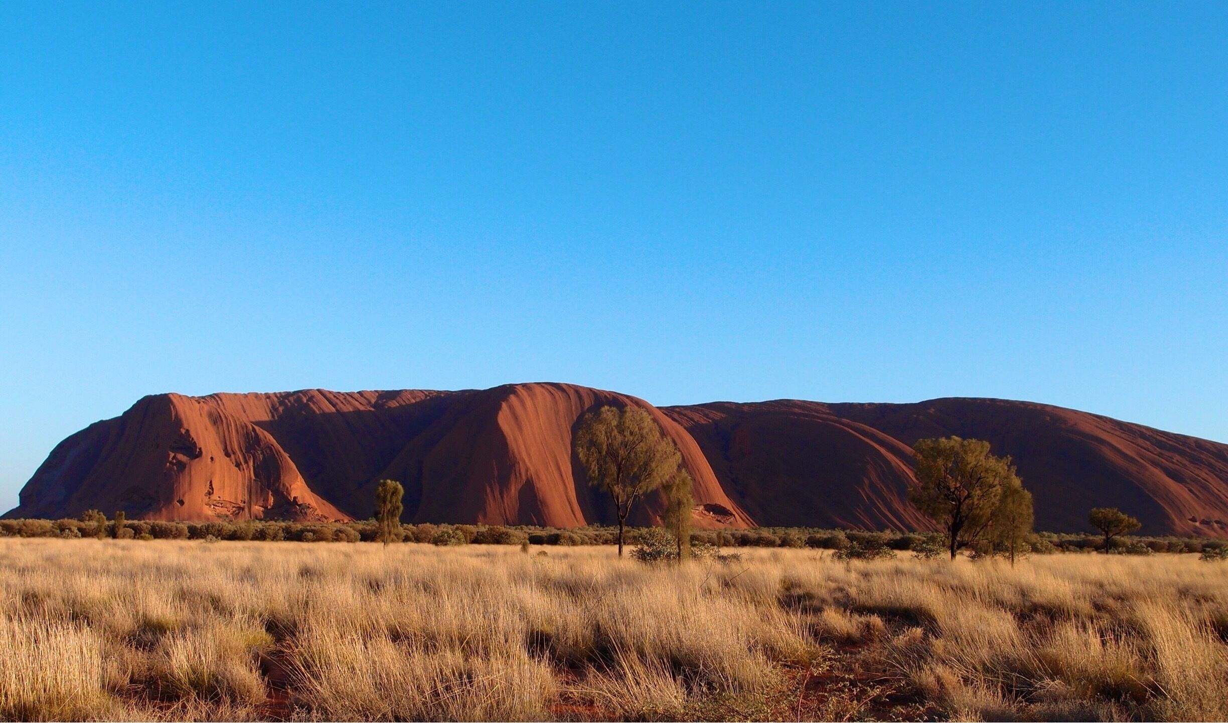 Ayers Rock now known as Uluru. You can't get the enormous scale of the rock until you visit for yourself. Don't go in Summer, it is way too hot.