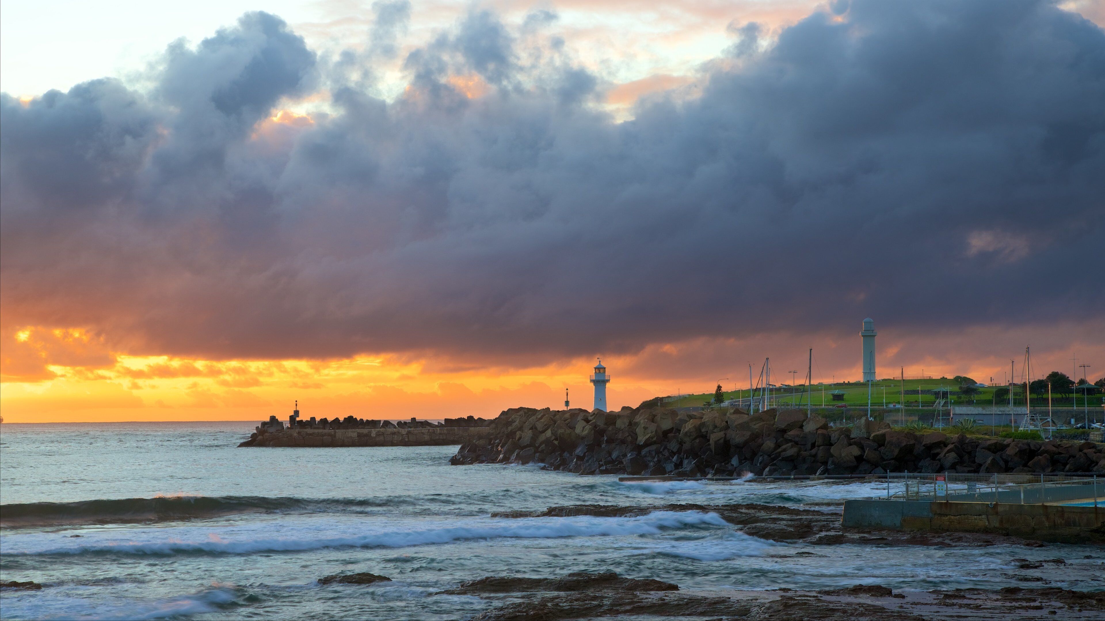 North Wollongong featuring a sunset, rugged coastline and a lighthouse