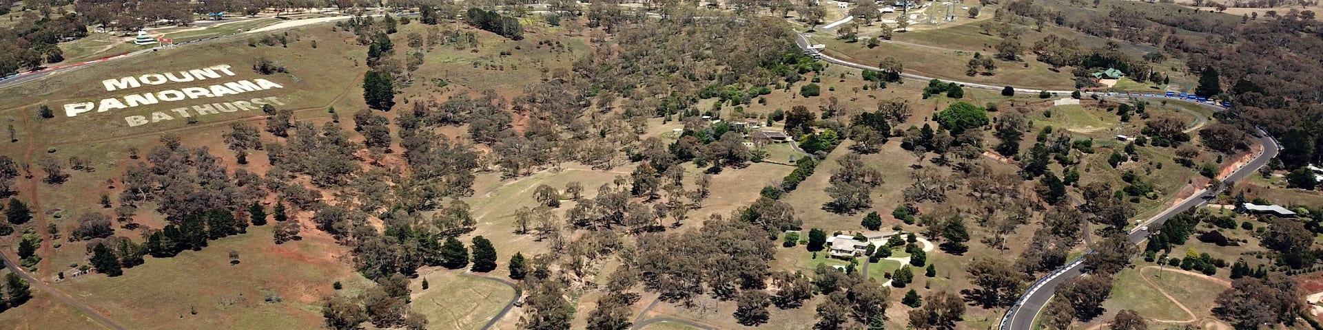 A vast landscape with a prominent sign reading 'Mount Panorama Bathurst.'
