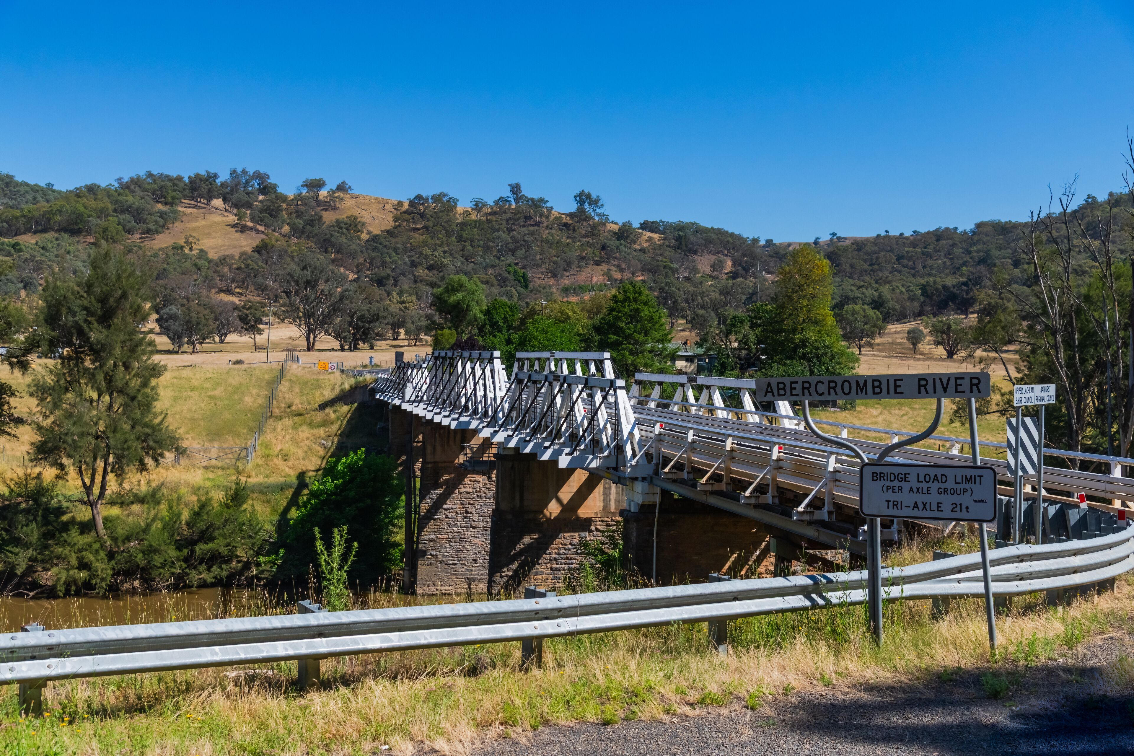 A bridge over the Abercrombie River with a bridge load limit sign.
