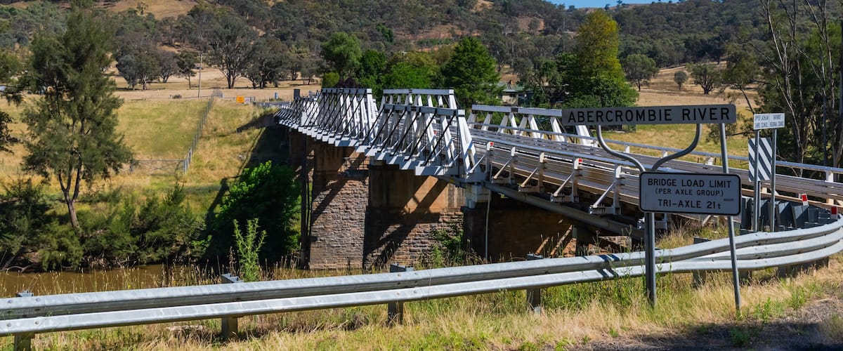 A bridge over the Abercrombie River with a bridge load limit sign.