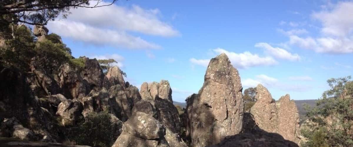 A rocky landscape with prominent rock formations and sparse vegetation.