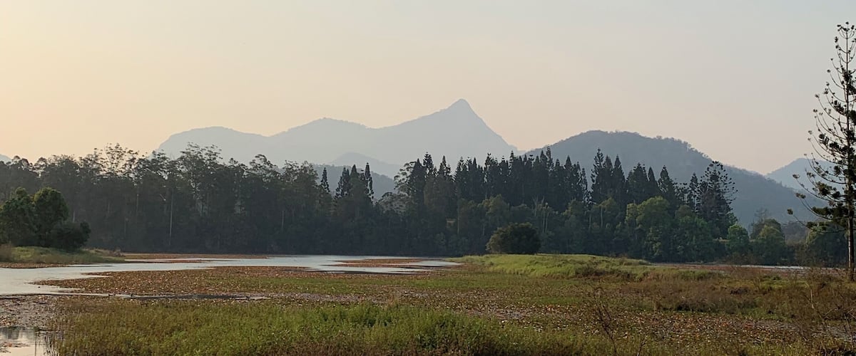 A river with a mountain range in the background.