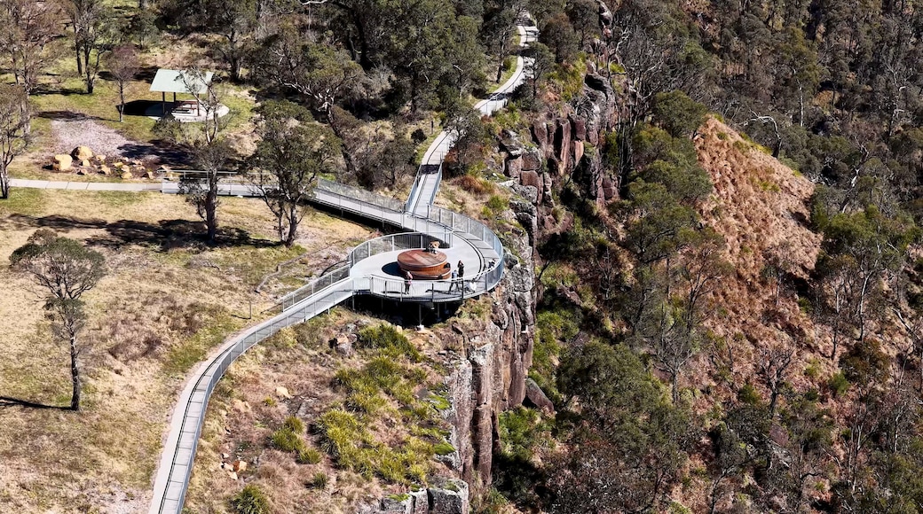 A winding road through a mountainous area with a circular viewing platform.