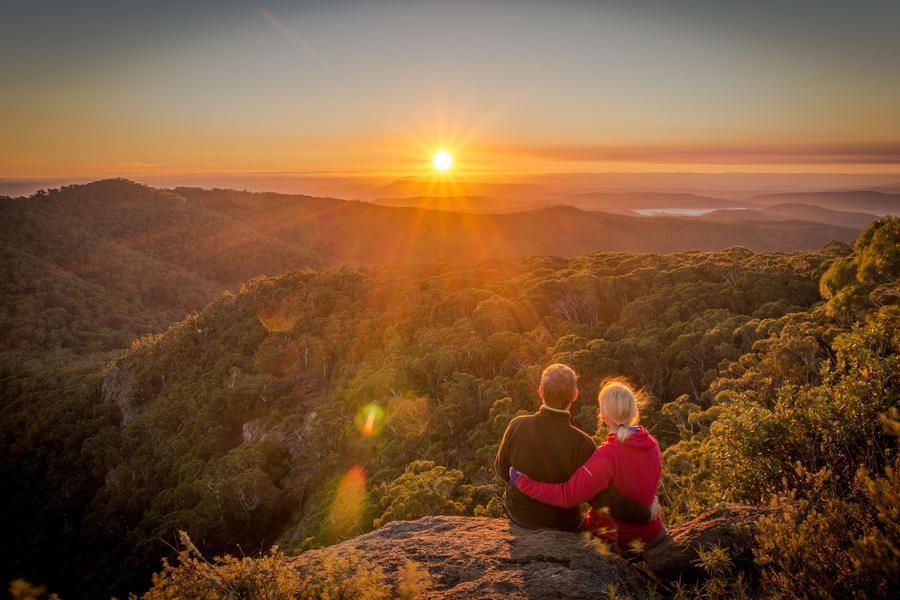 A young couple enjoying the beautiful sunrise on Mount Kaputar in New South Wales Australia, Shutterstock ID 1154507251, Purchase Order: -