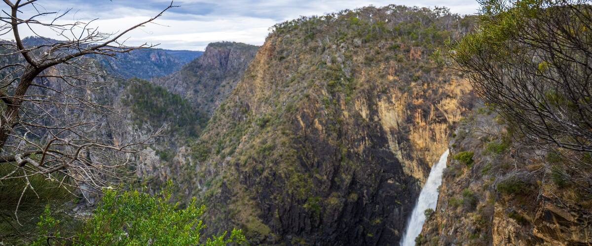 A canyon with a waterfall.