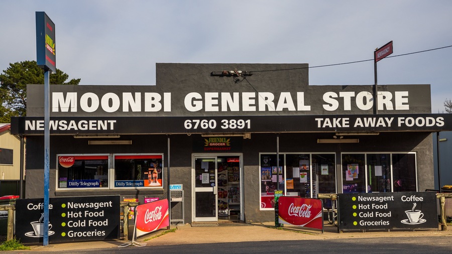 A Moonbi General Store with a Coca-Cola sign and a newsagent sign.