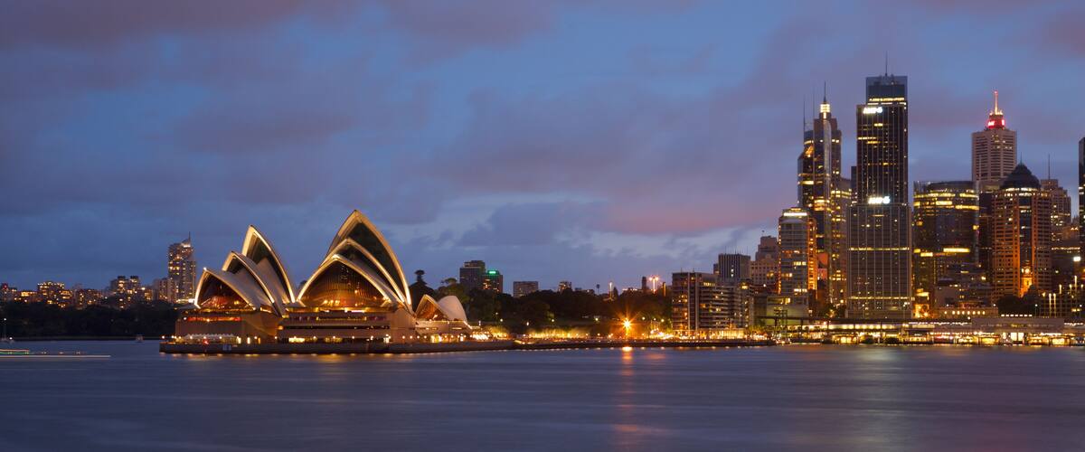 The Sydney Opera House and Sydney skyline at dusk.