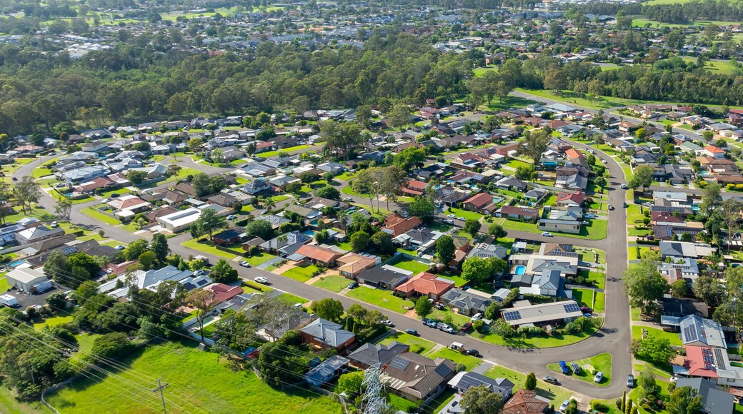 A residential area with houses, roads, and greenery.