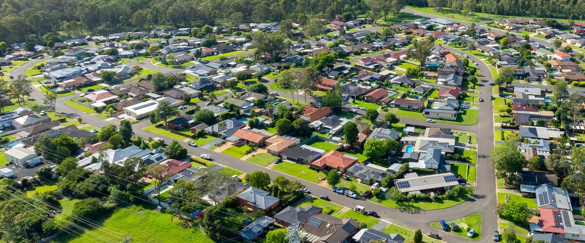 Un barrio residencial con casas, calles y zonas verdes.