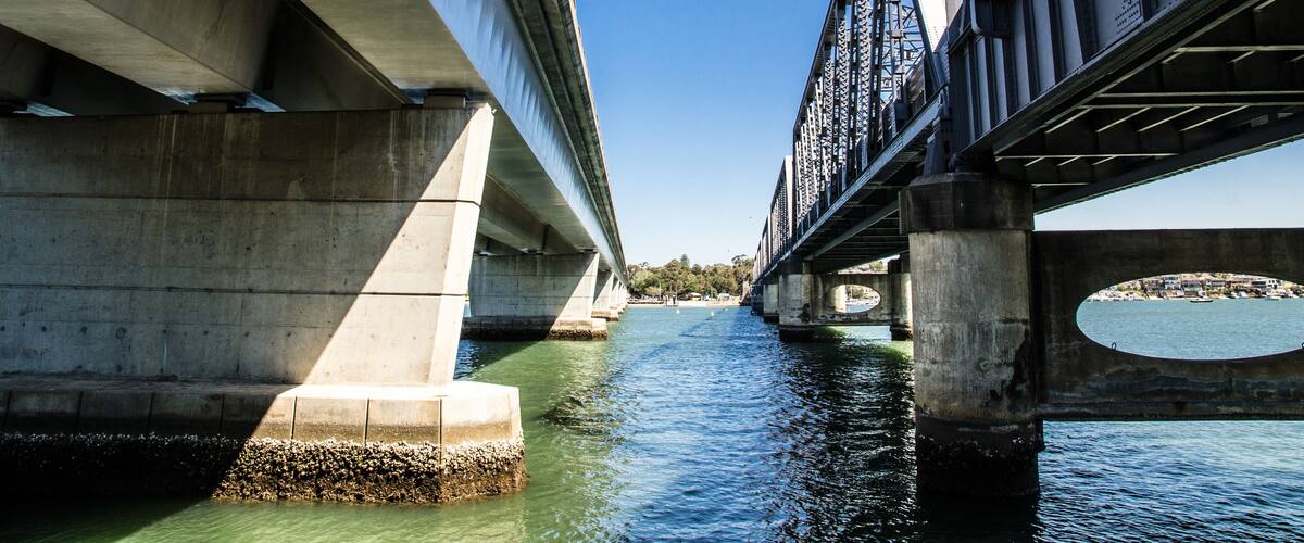 A bridge over a river with clear blue skies.