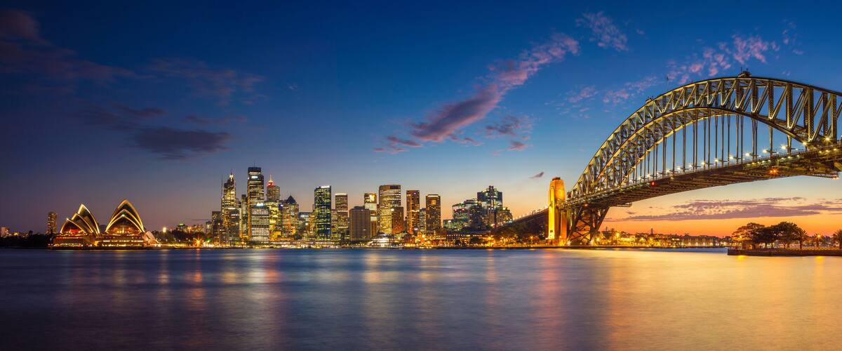 The Sydney Opera House and Sydney Harbour Bridge at dusk.