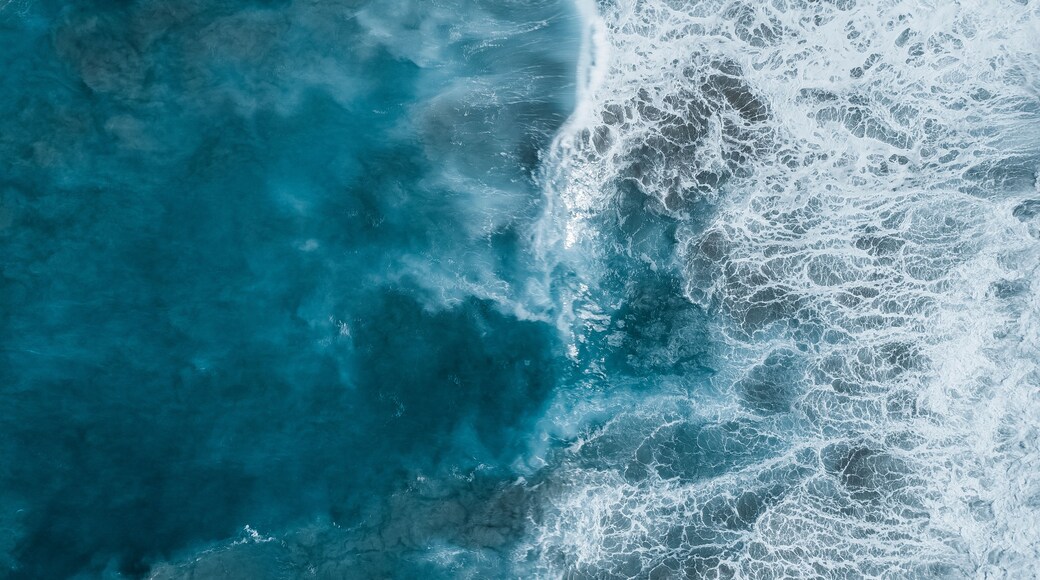 A turbulent ocean with waves crashing onto the shore.