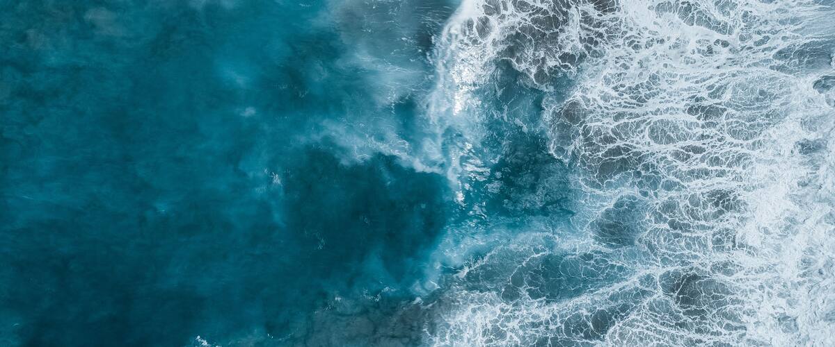 A turbulent ocean with waves crashing onto the shore.