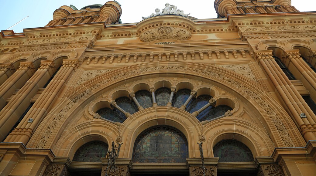 An ornate building with intricate architectural details, including a large arched entrance and decorative columns.