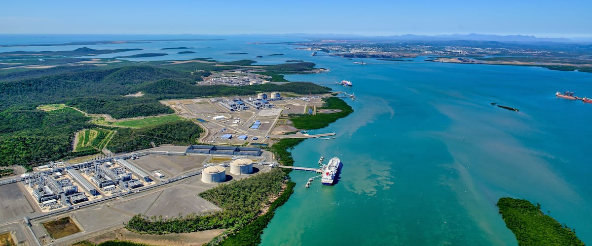 An industrial area with a large body of water, a dock, and a ship.