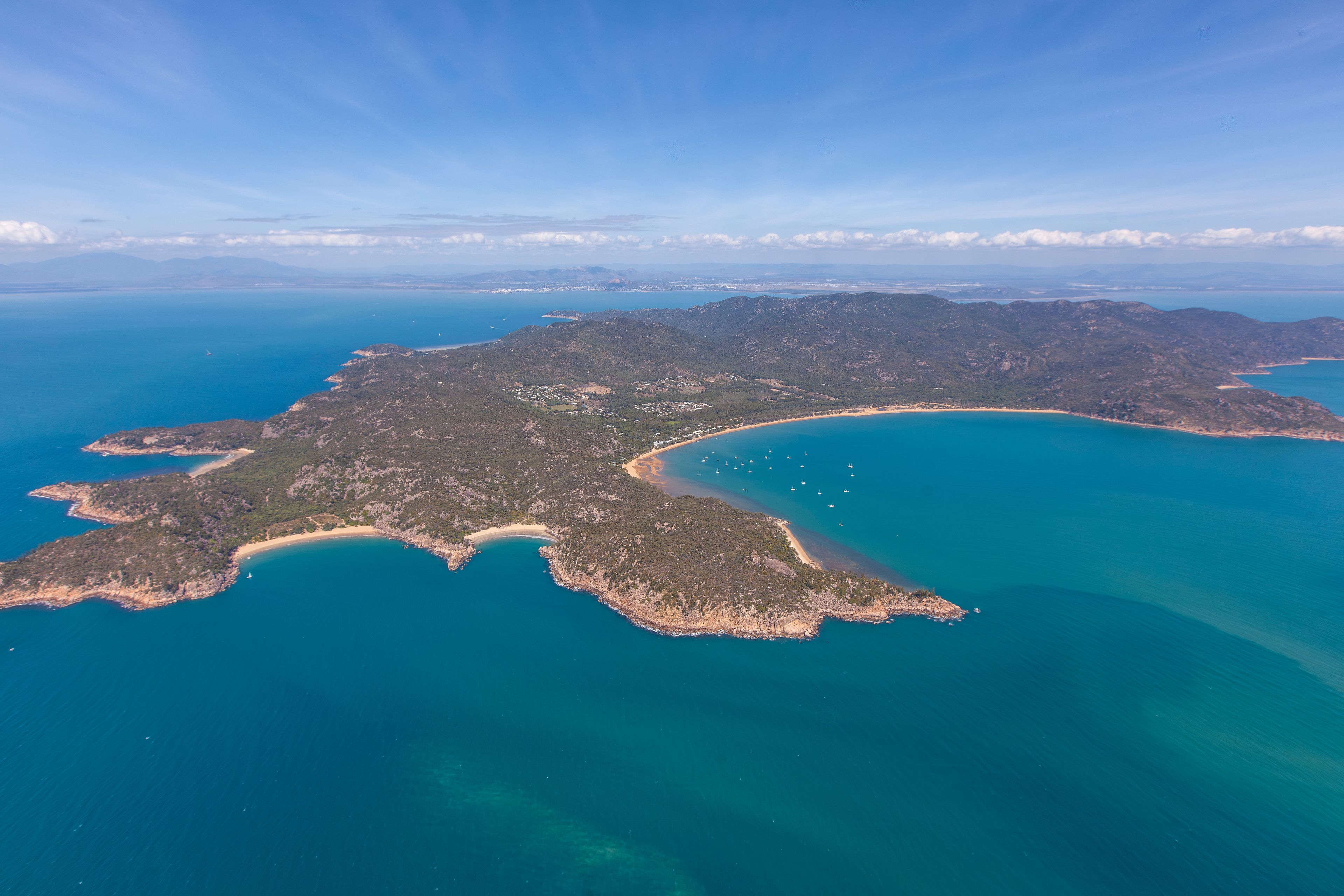 Florence Bay aerial view of island beach, coast and blue water on Magnetic Island