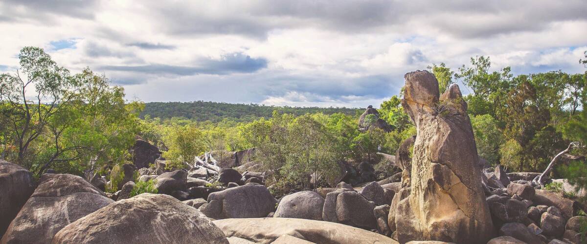 A rocky landscape with large boulders and trees.