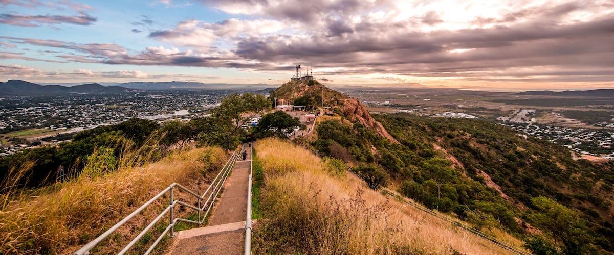 A viewpoint overlooking a city with a prominent hilltop structure.