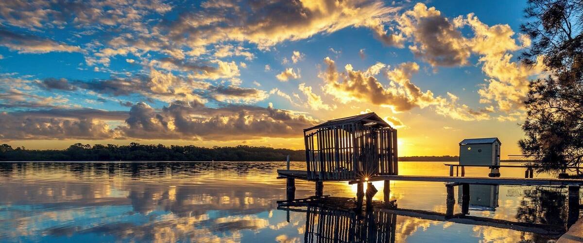 Another shot on the Maroochy river with almost perfect reflection of the clouds framing the little boathouse