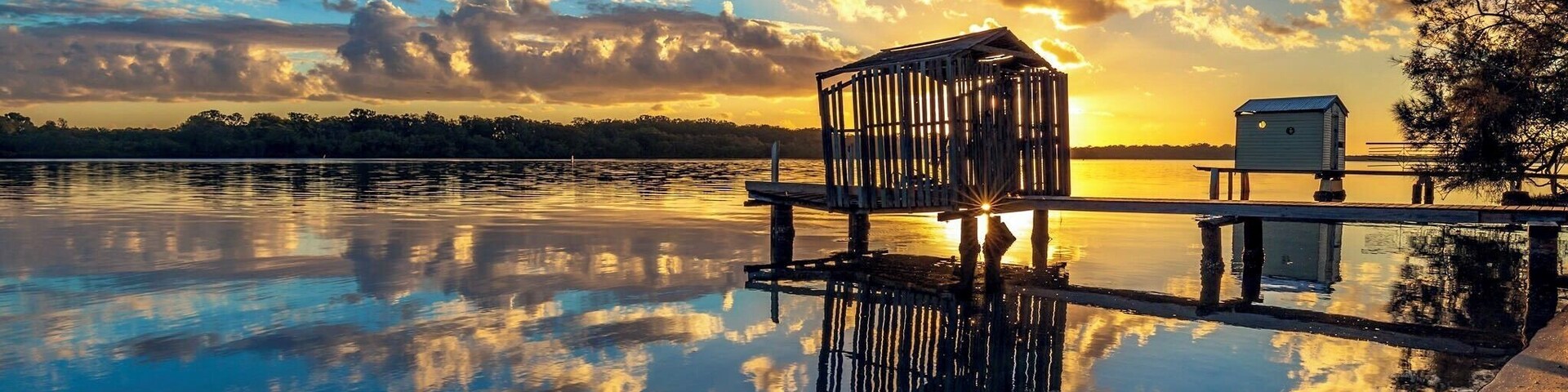 Another shot on the Maroochy river with almost perfect reflection of the clouds framing the little boathouse