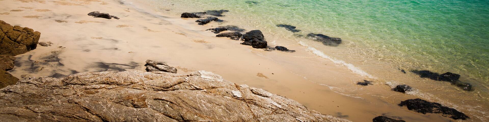 Ideal beach on Keppel Island, Queensland, Australia. Sun-soaked sand beside the turquoise ocean at the start of the Great Barrier Reef.