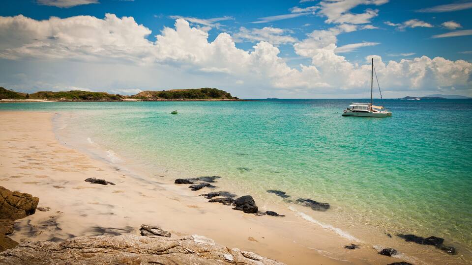 Ideal beach on Keppel Island, Queensland, Australia. Sun-soaked sand beside the turquoise ocean at the start of the Great Barrier Reef.