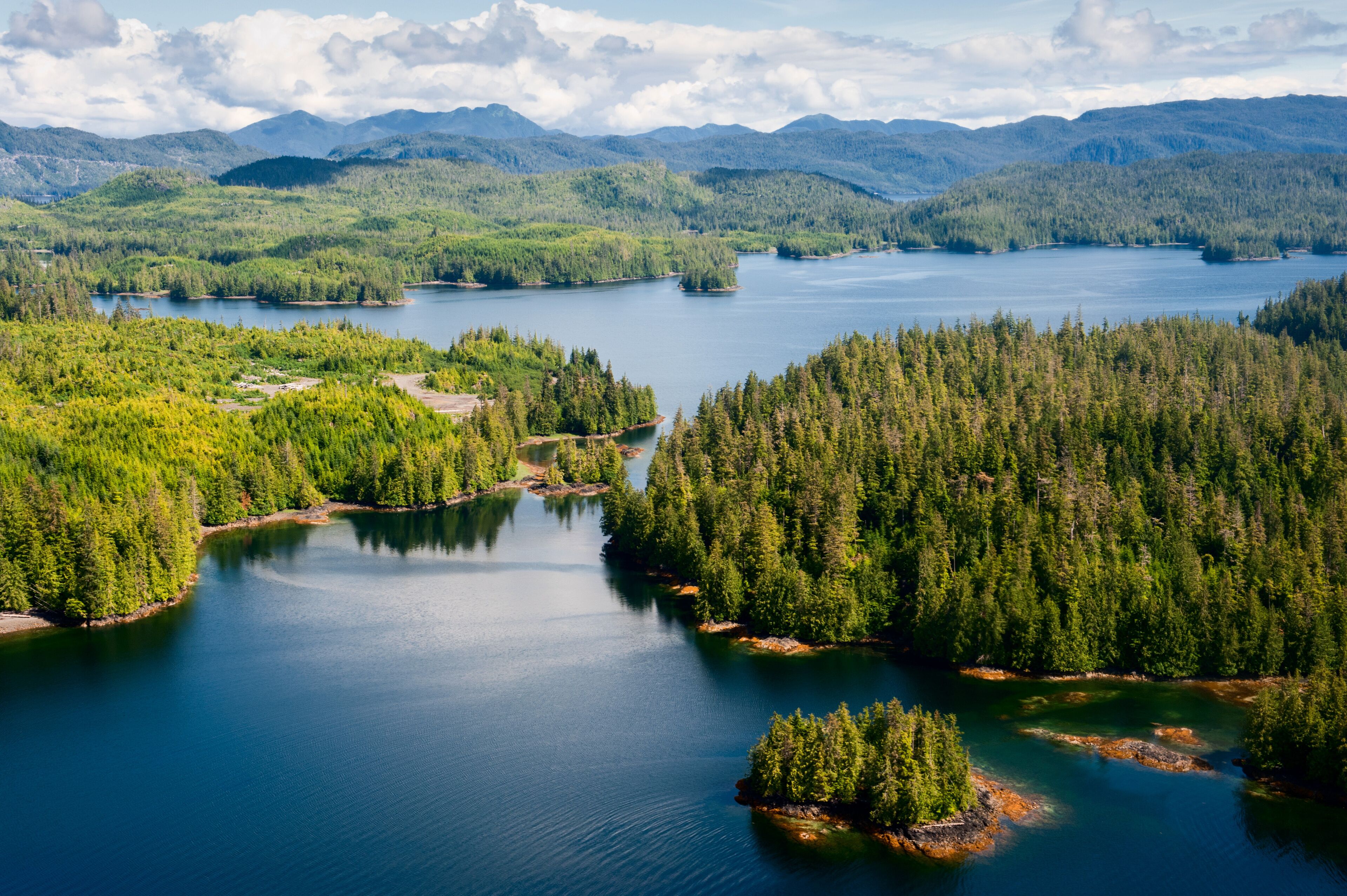 A lake surrounded by dense forests and mountains.