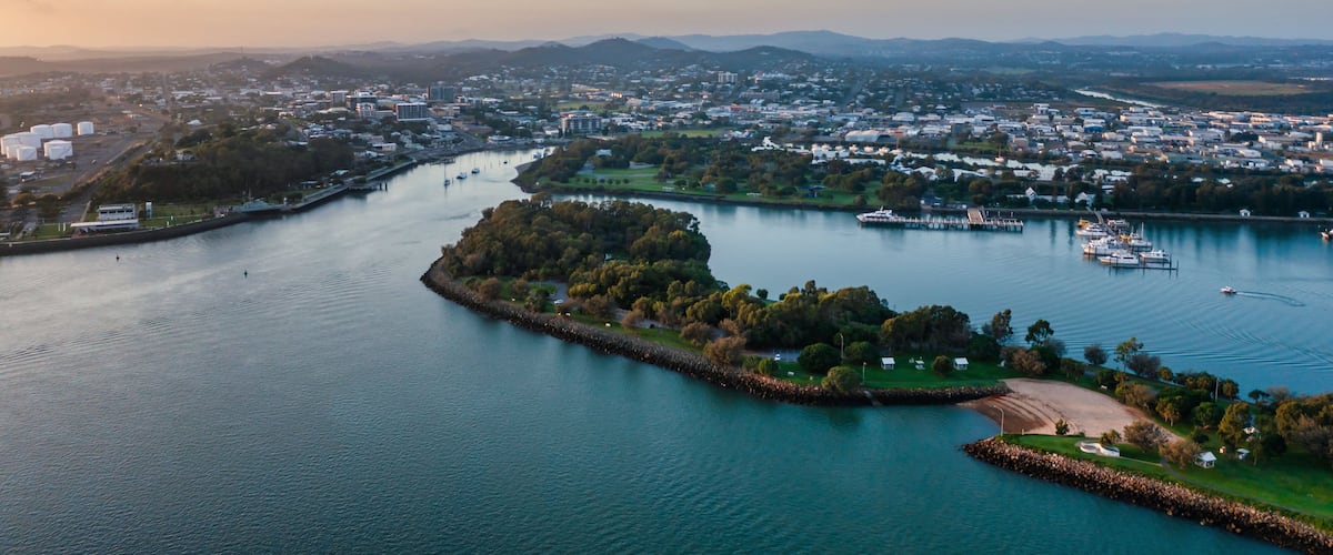 A river meandering through a city with a park and marina.