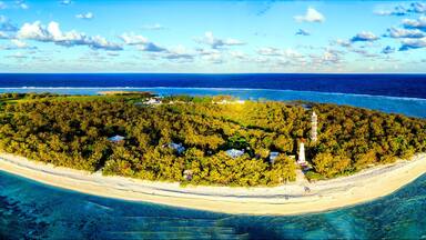 Aerial view of Lady Elliot Island coral reef in Queensland Australia. The lighthouse is visible on the bottom right. This is the first island of the great barrier reef.