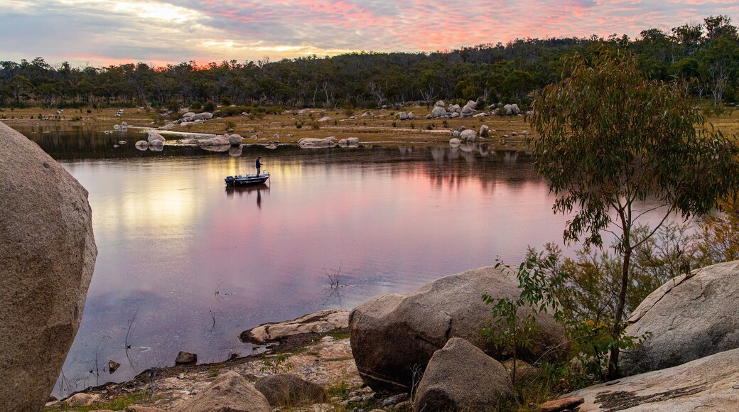 Leslie Dam which includes a lake or waterhole and a sunset