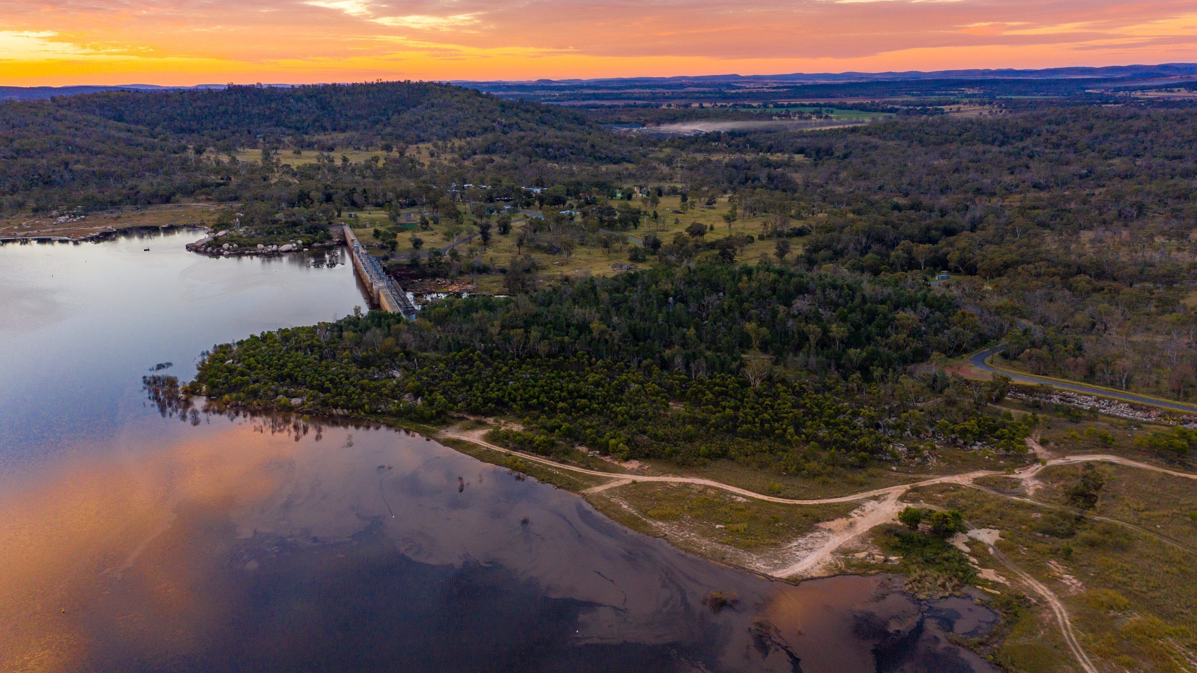 Leslie Dam featuring landscape views, a sunset and a lake or waterhole
