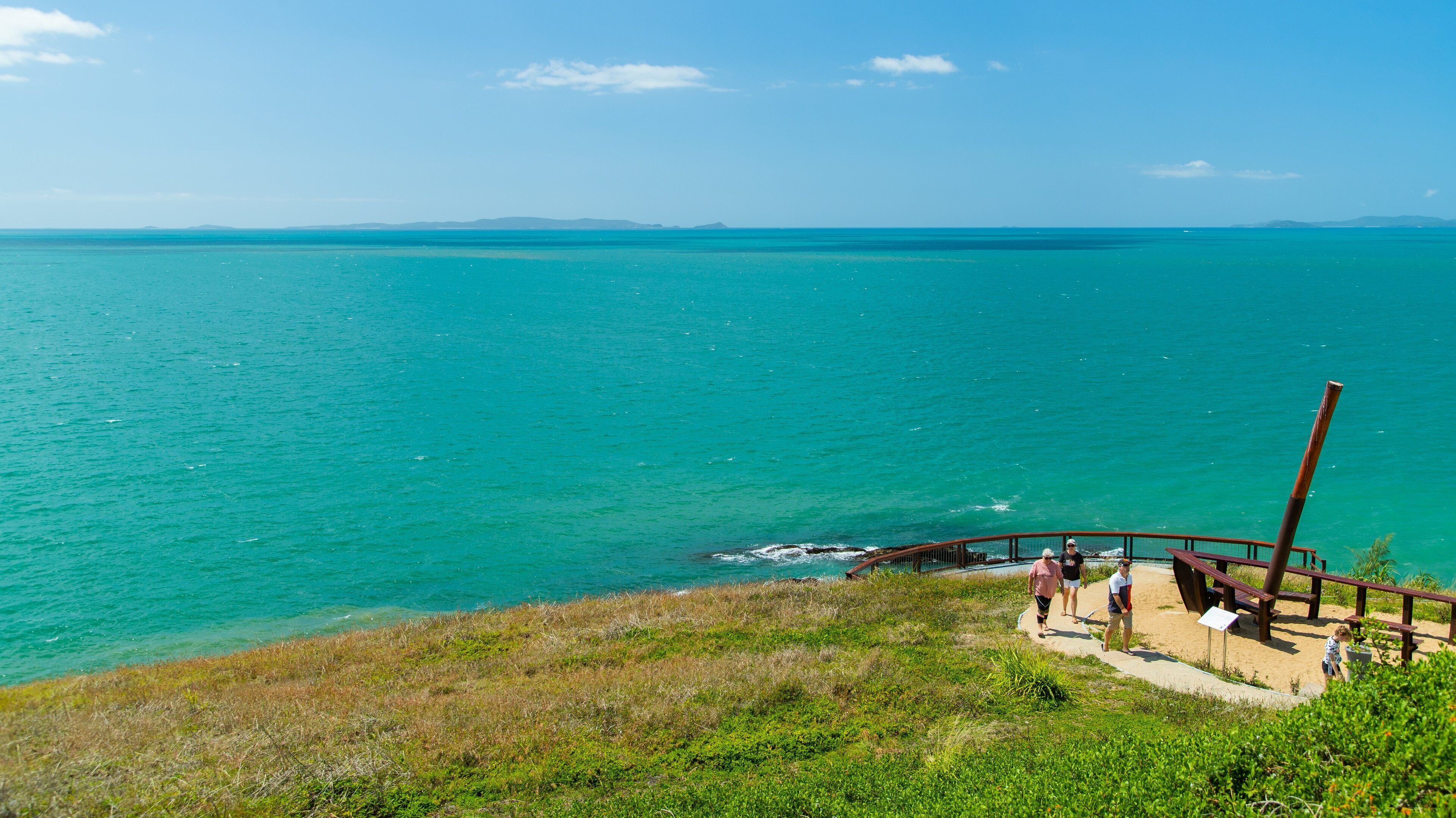 Cooee Bay showing general coastal views as well as a small group of people