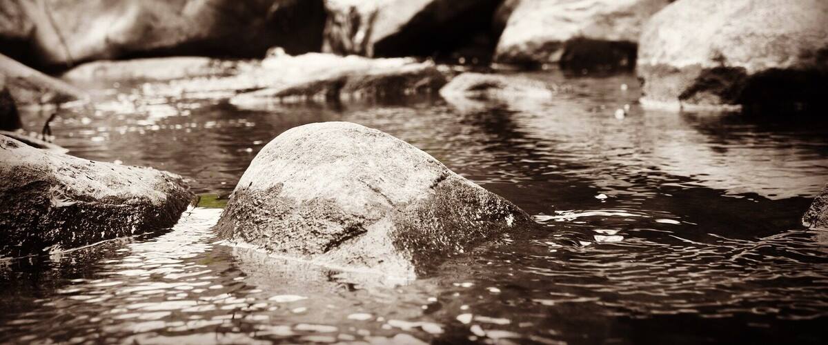 A river with large rocks and clear water.