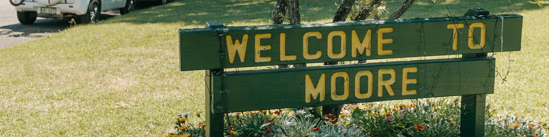 Moore which includes signage, a park and wildflowers