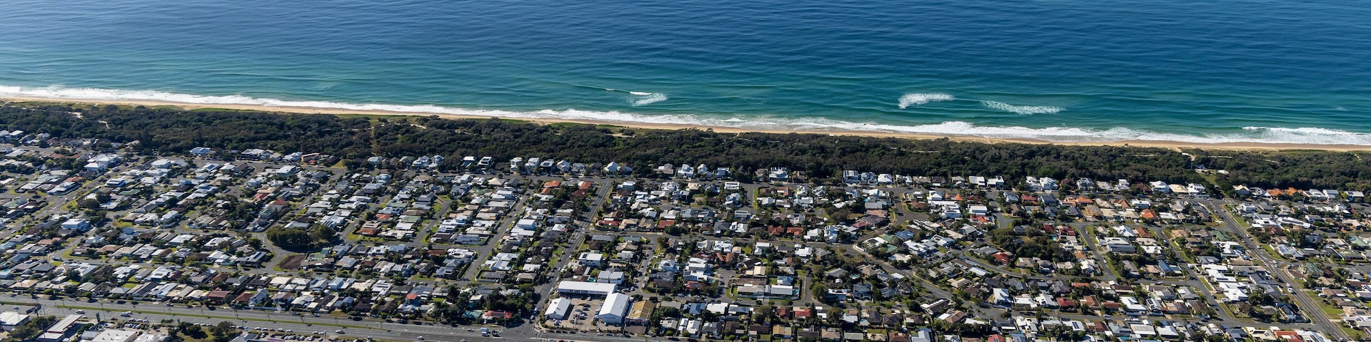 Aerial view of a residential district at Bokarina Foreshore Bushland Reserve along the coastline in Sunshine Beach, Queensland, Australia.