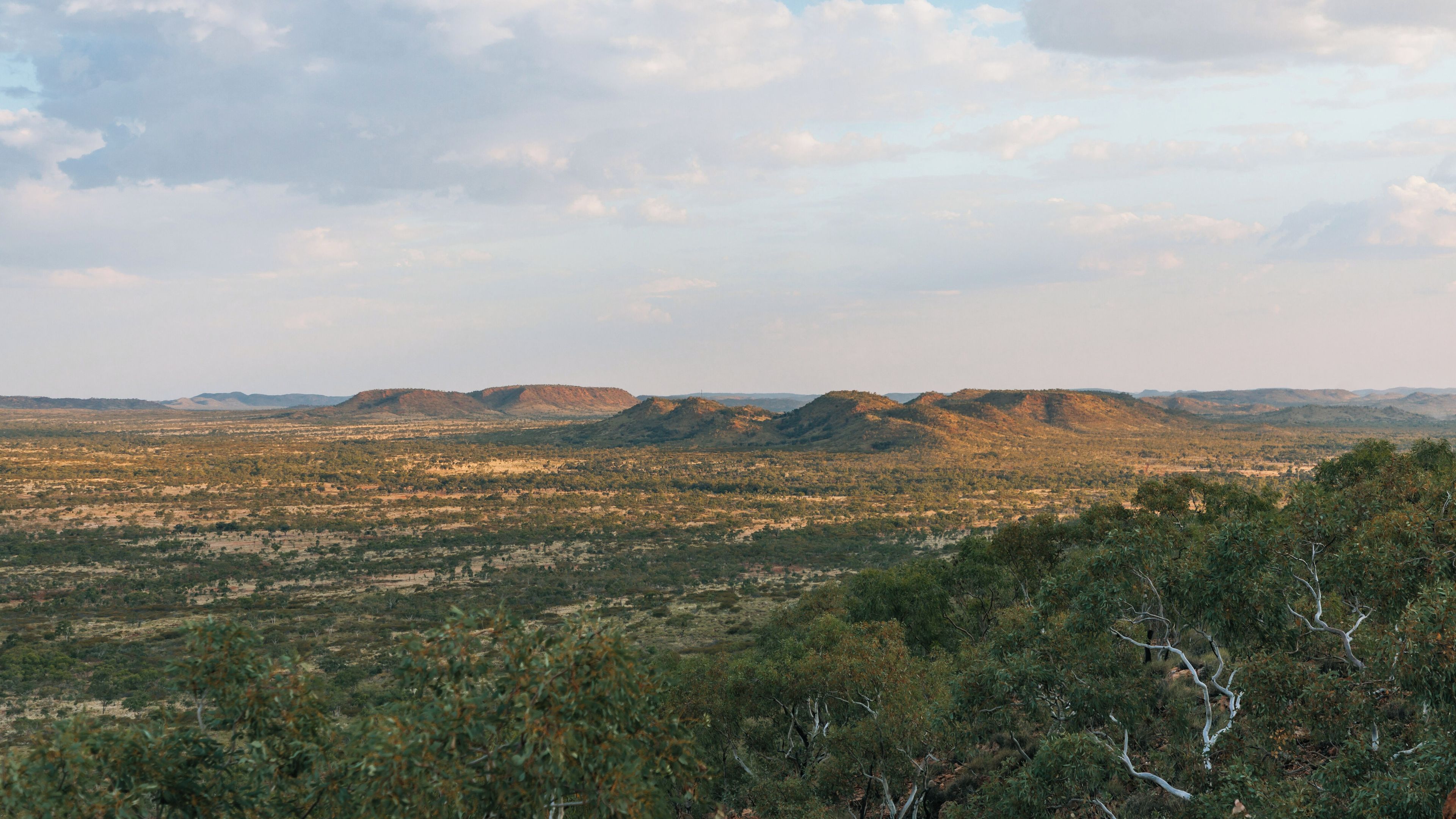 A vast landscape with rolling hills and sparse vegetation.