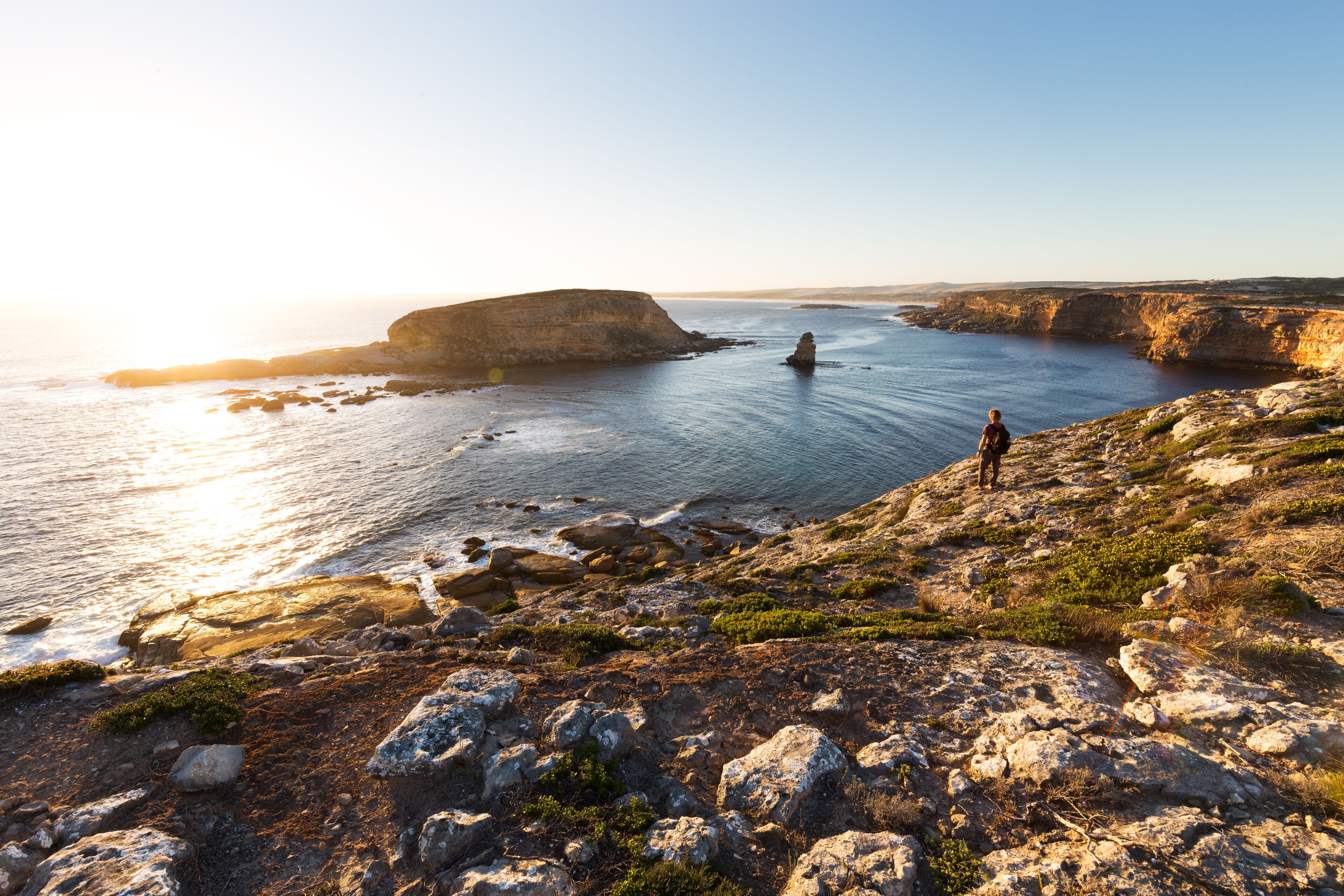 Person looking at beautiful ocean sunset on rugged coastline in South Australia