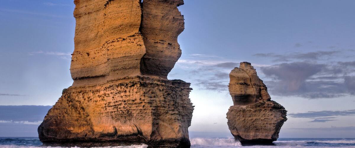 Two large rock formations by the ocean.