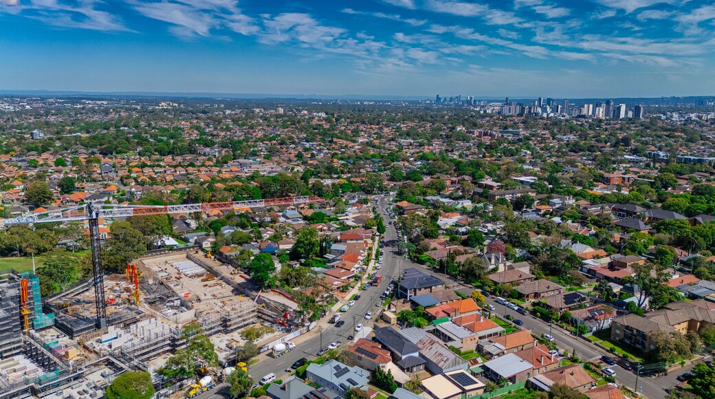 Aerial Drone view of Sydney Urban Sprawl and Suburban housing Suburb of Ashbury and Croydon with roof tops, the streets and the parks NSW Australia