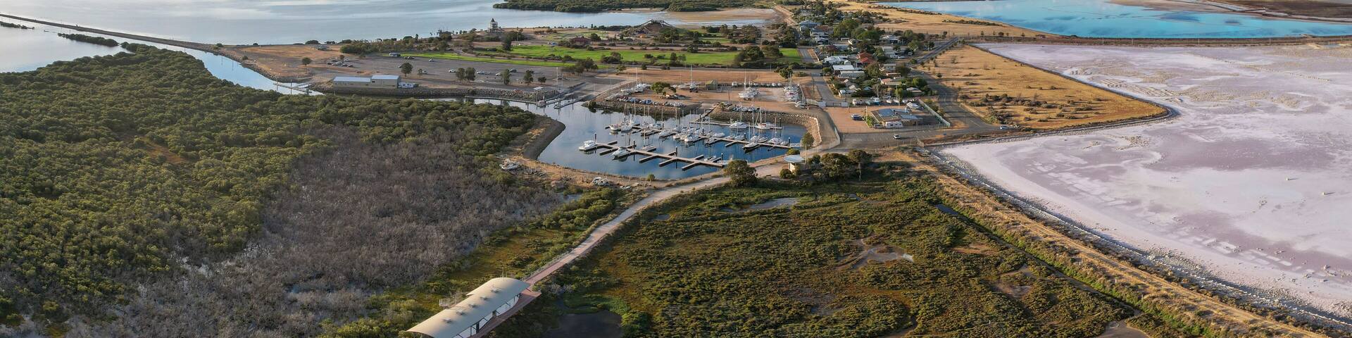 Aerial view of serene st kilda mangrove trail and salt flats with a picturesque harbour, st kilda, south australia.
