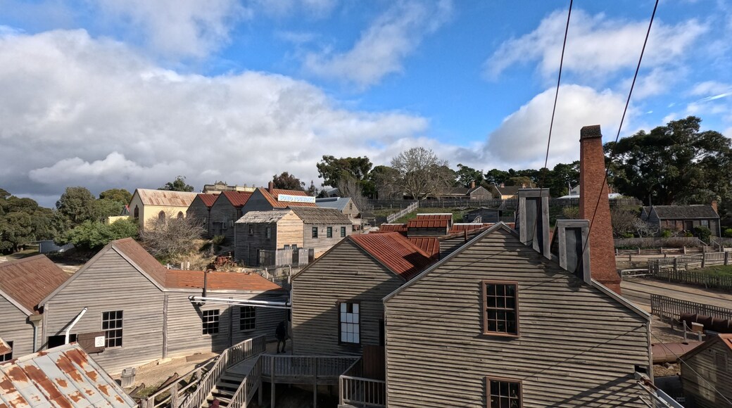 A historical town with wooden buildings and a prominent church steeple.