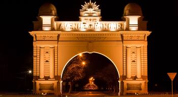 A large illuminated archway with the words 'AVENUE OF HONOUR' and 'VICTORY' on it.