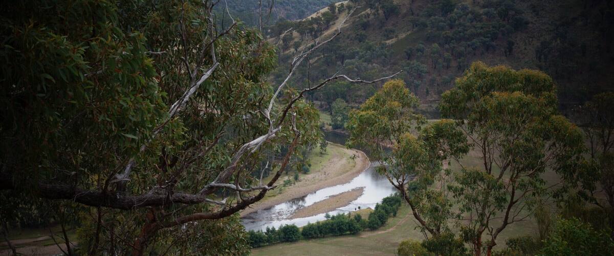 A river winding through a valley with hills in the background.