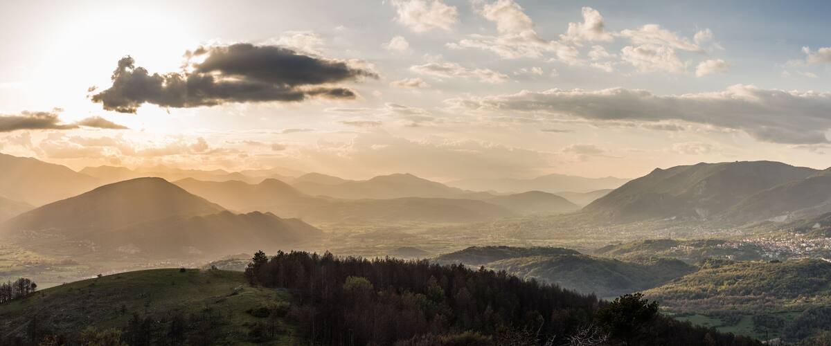 A mountainous landscape with a valley and a town.
