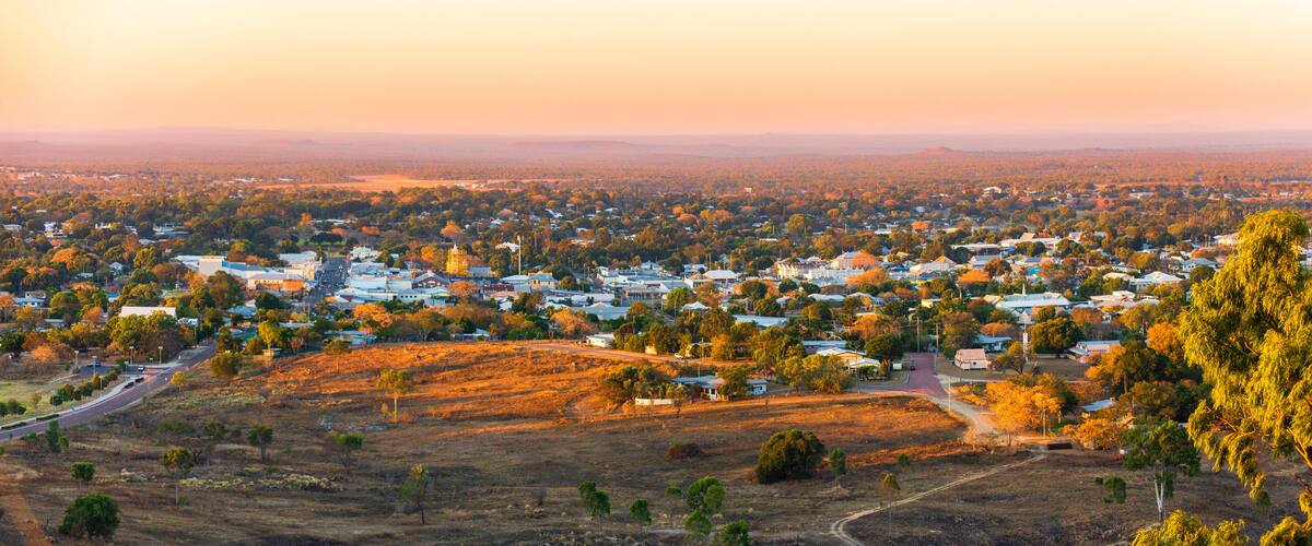 A town with a prominent church, rolling hills, and a mix of residential and commercial buildings.
